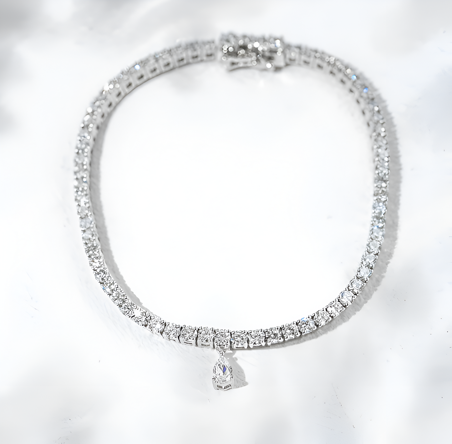 Silver bracelet with clear stones on a white background
