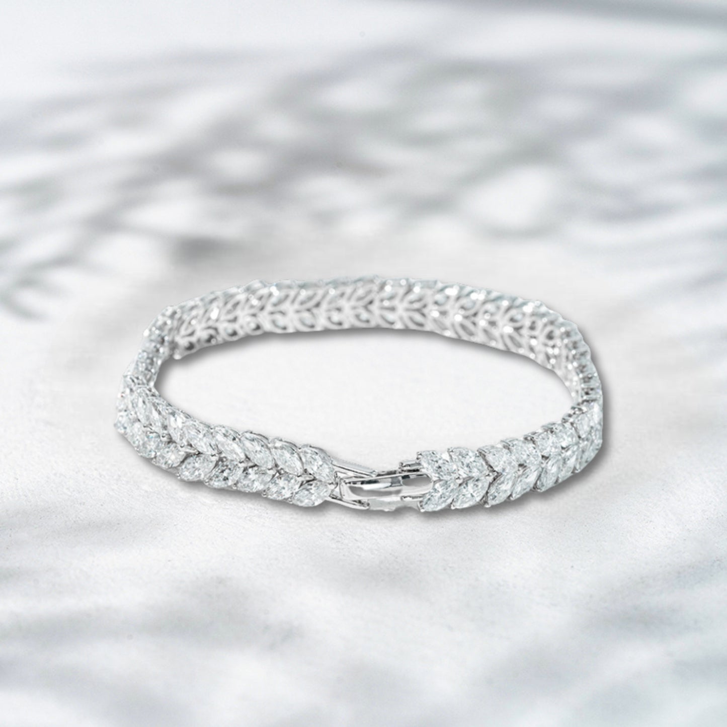 Silver bracelet with intricate design on a light gray background