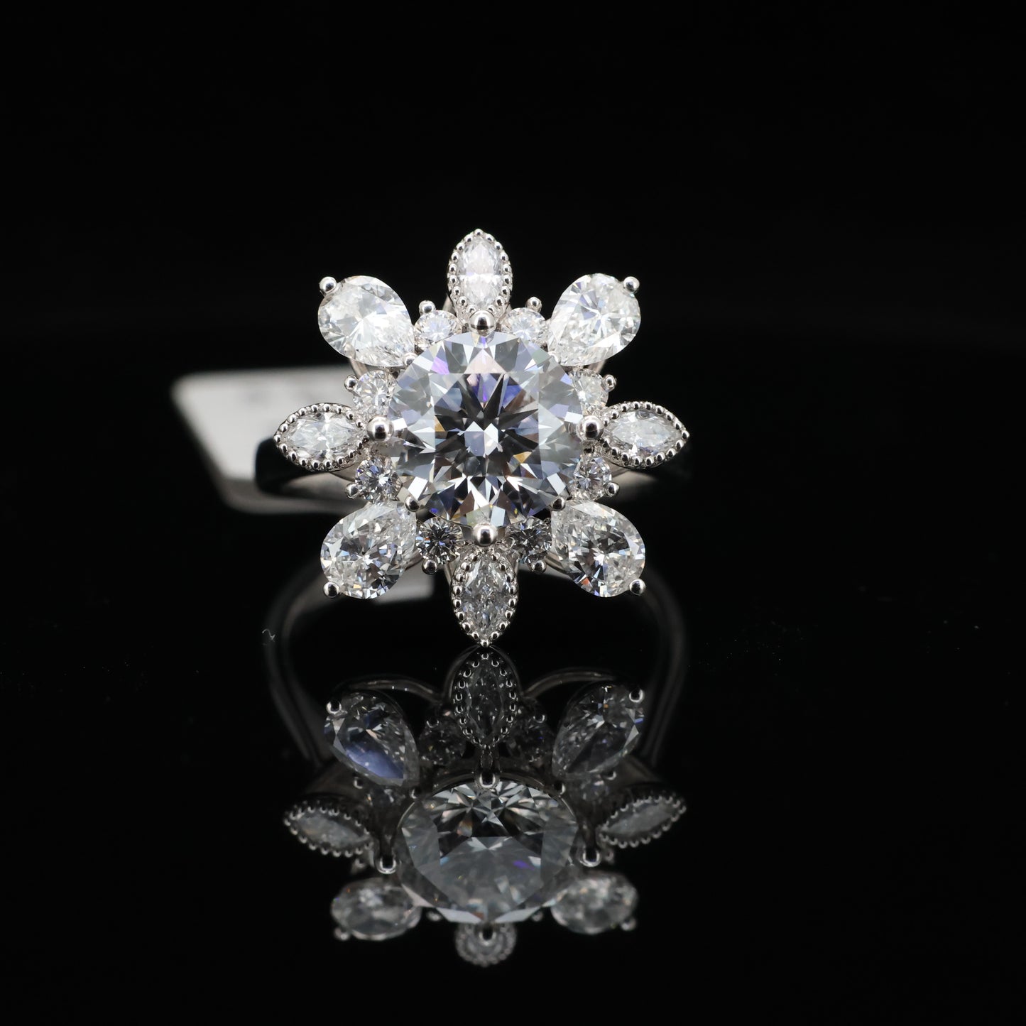 Diamant ring with pear-shaped diamonds on a black background