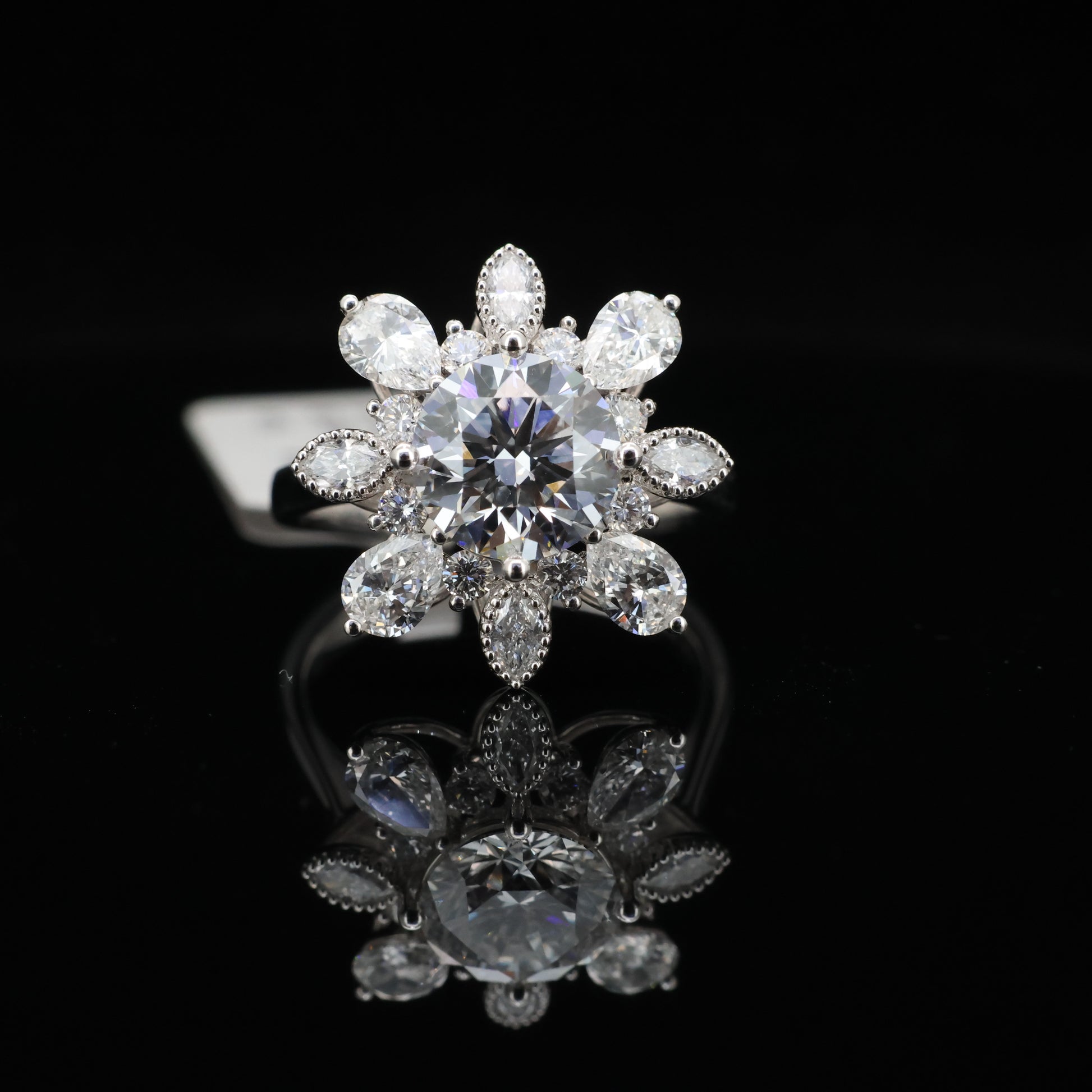 Diamant ring with pear-shaped diamonds on a black background