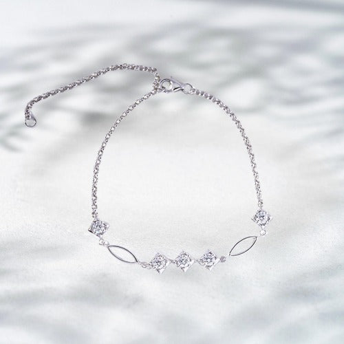 Silver bracelet with diamond-like stones on a light background
