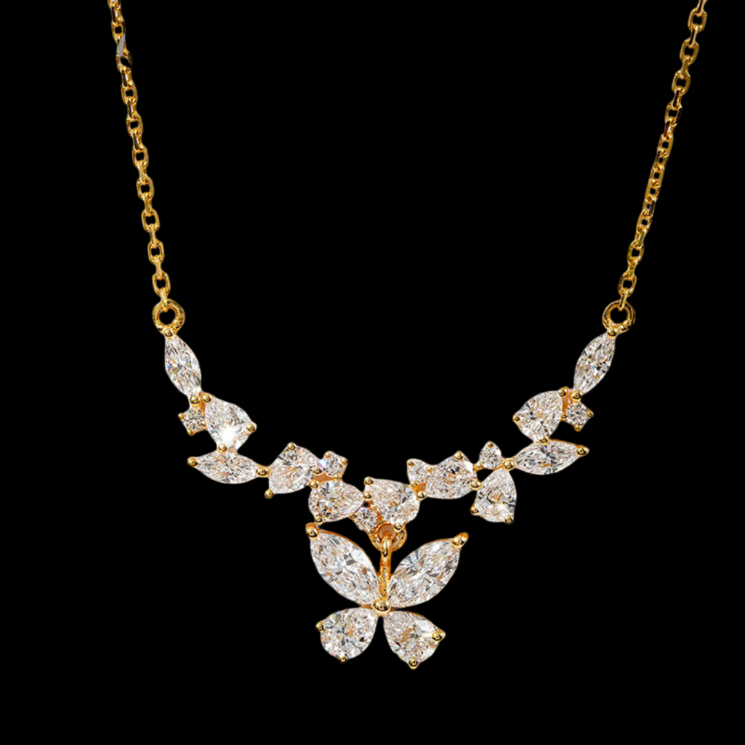 Gold necklace with diamond leaf design on a black background