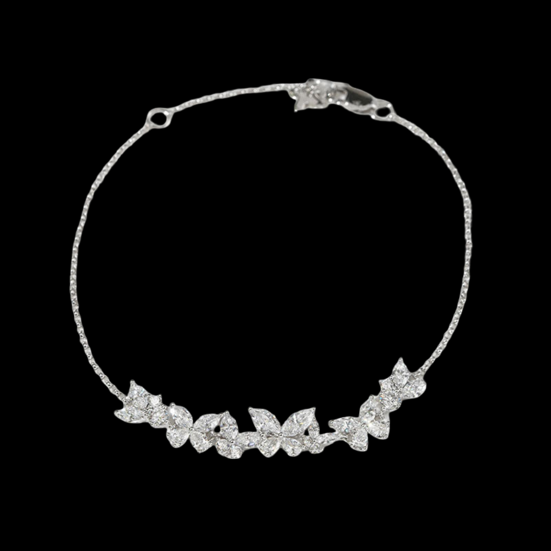 Silver necklace with leaf-like design on a black background