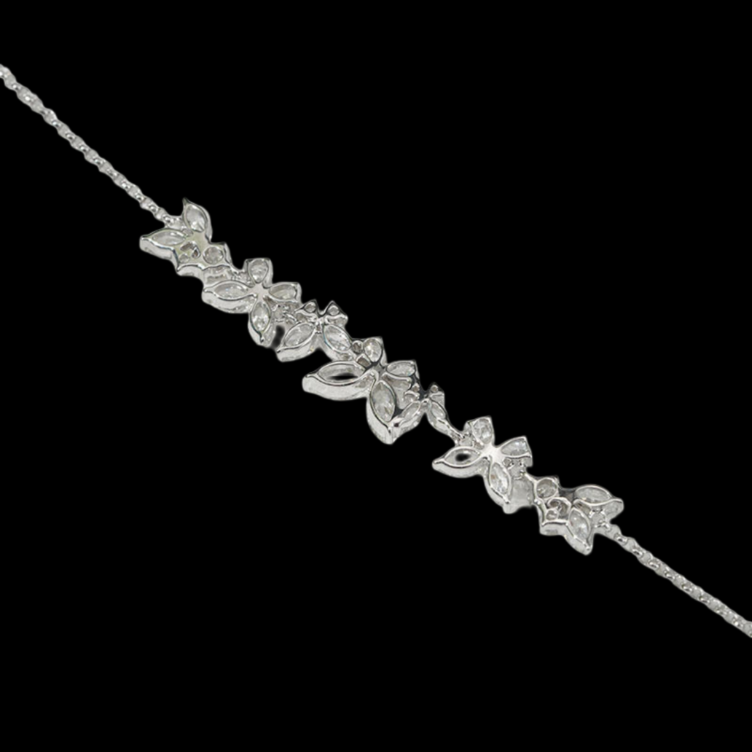 Silver bracelet with floral designs on a black background