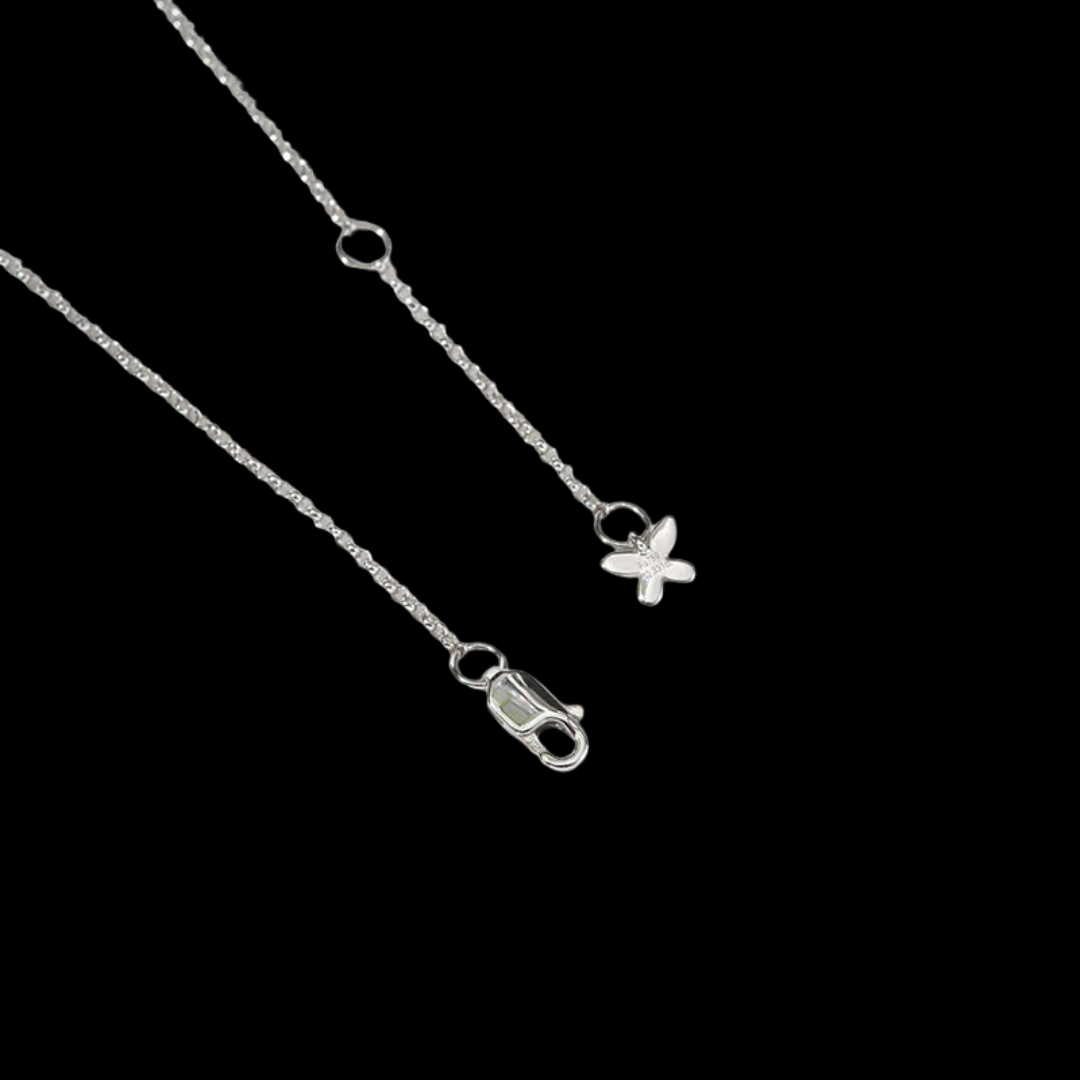 Silver anklet with a butterfly charm on a black background