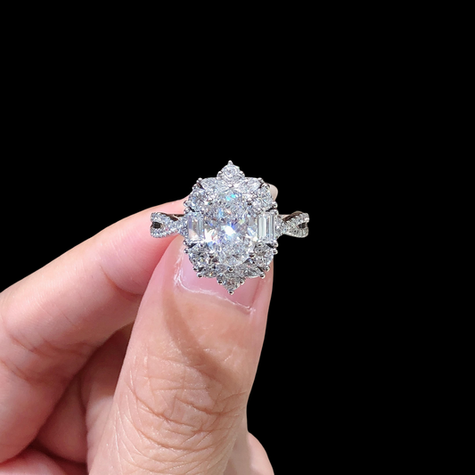 Diamond ring held between fingers against a black background