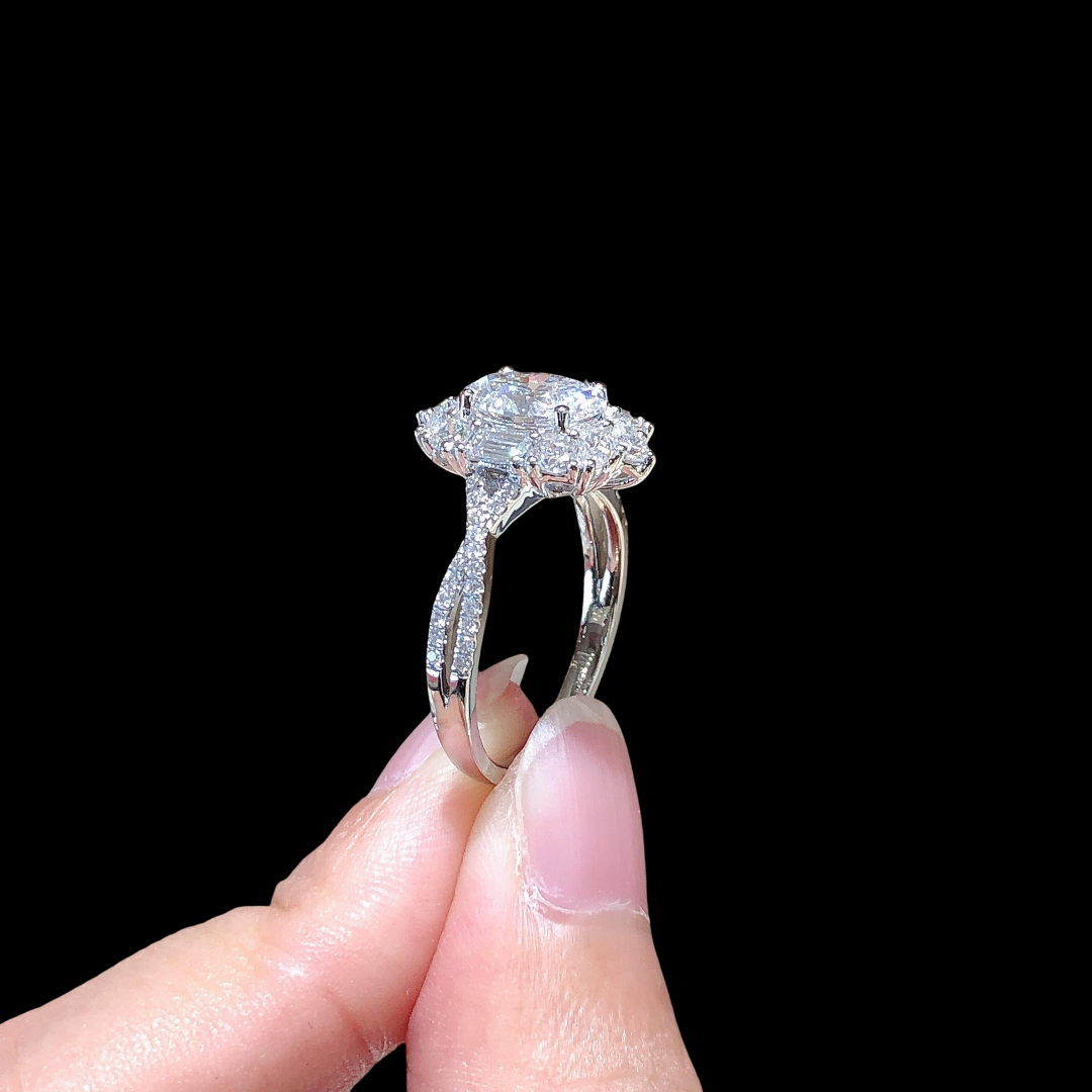 Diamond ring held between fingers against a black background