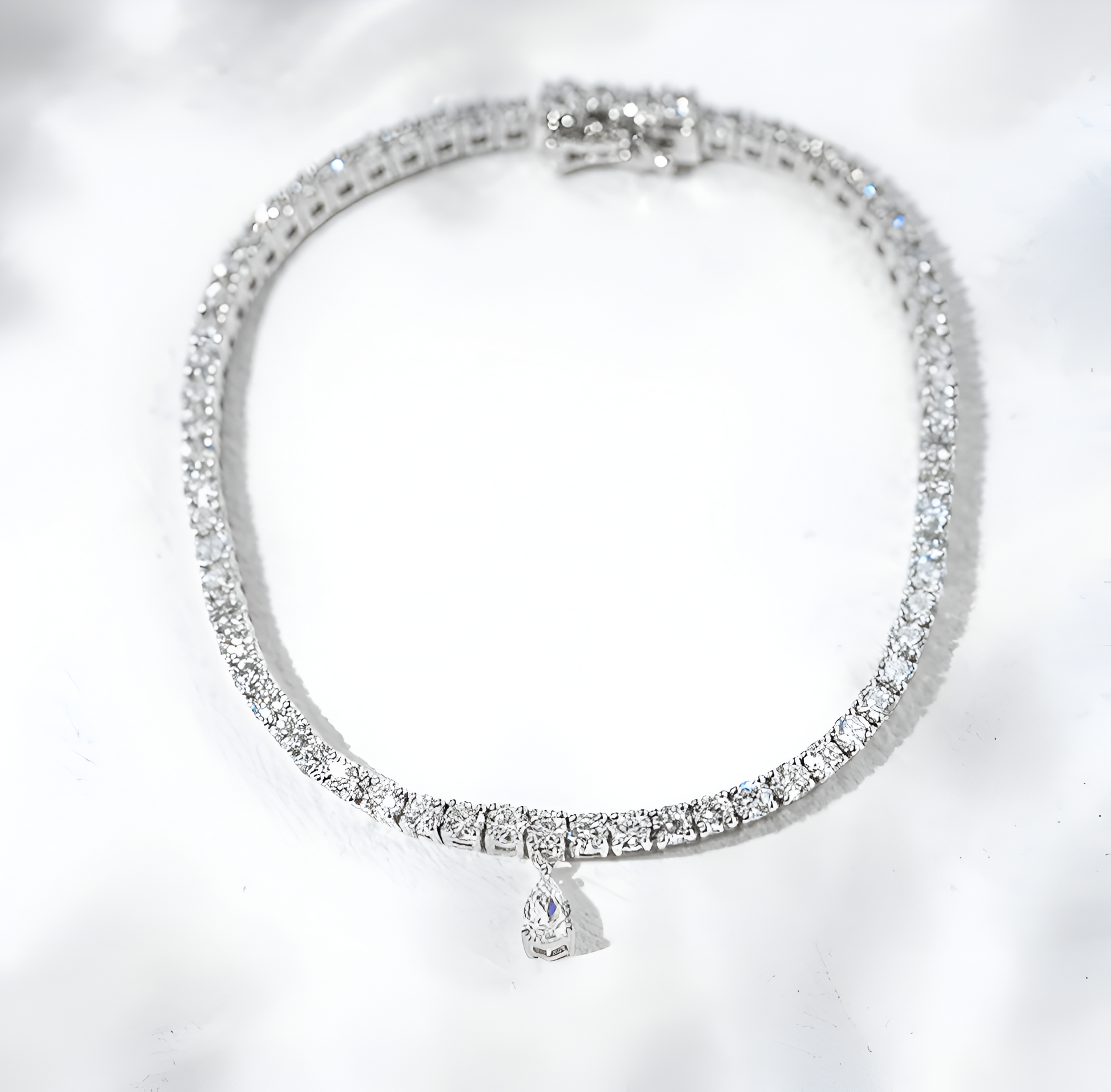 Silver bracelet with clear stones on a white background