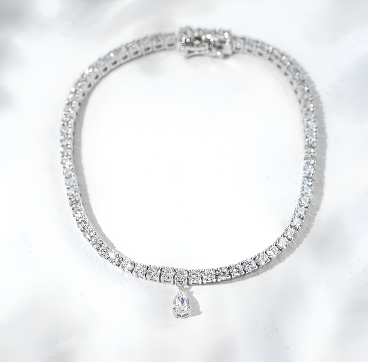 Silver bracelet with clear stones on a white background