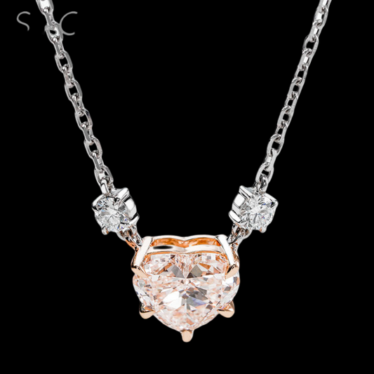 Heart-shaped diamond pendant on a chain against a black background