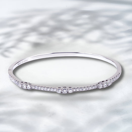 Silver ring with small diamonds on a textured silver background