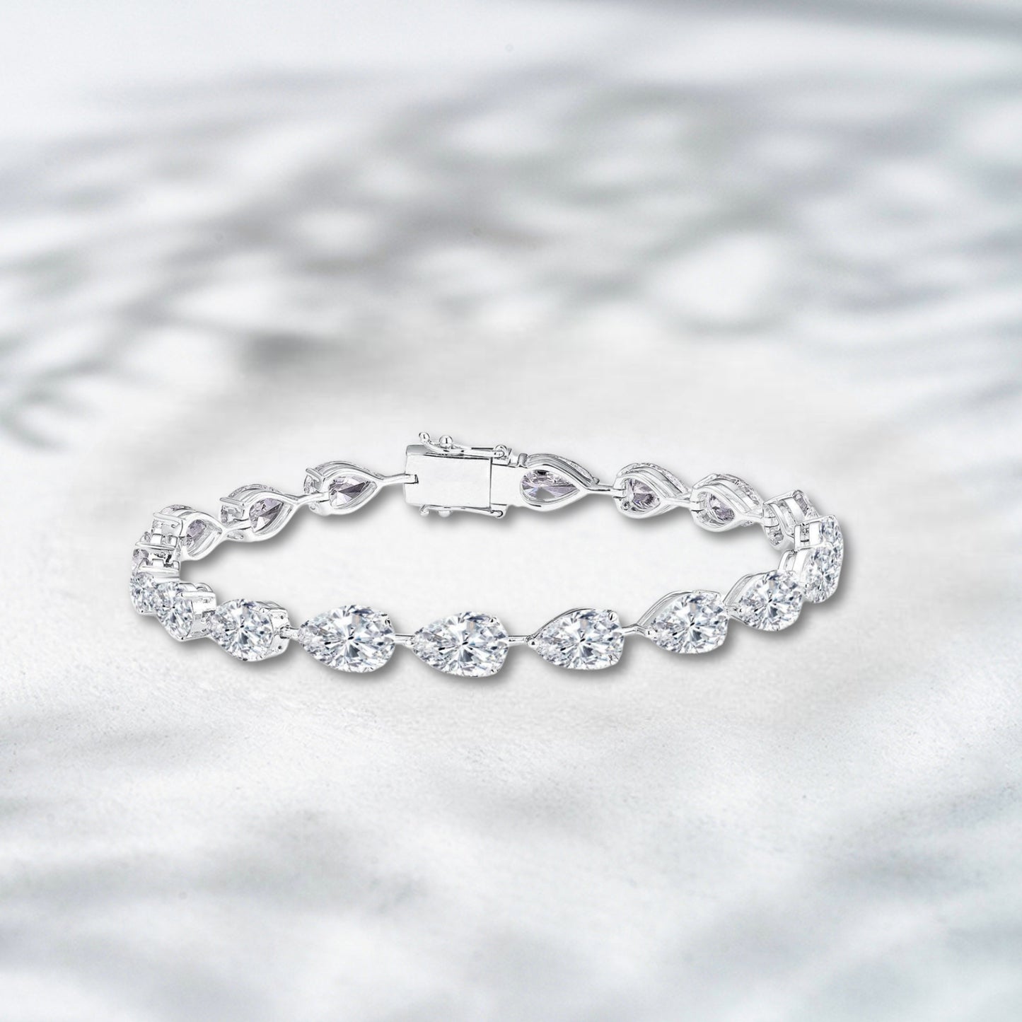 Silver bracelet with a clear clasp on a light gray background