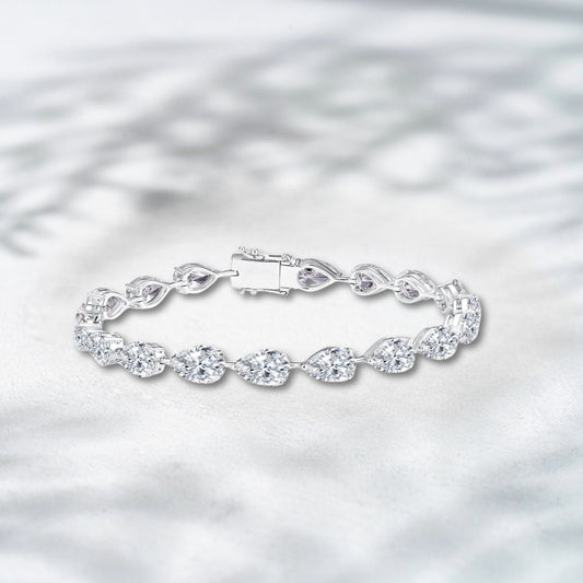 Silver bracelet with a clear clasp on a light gray background