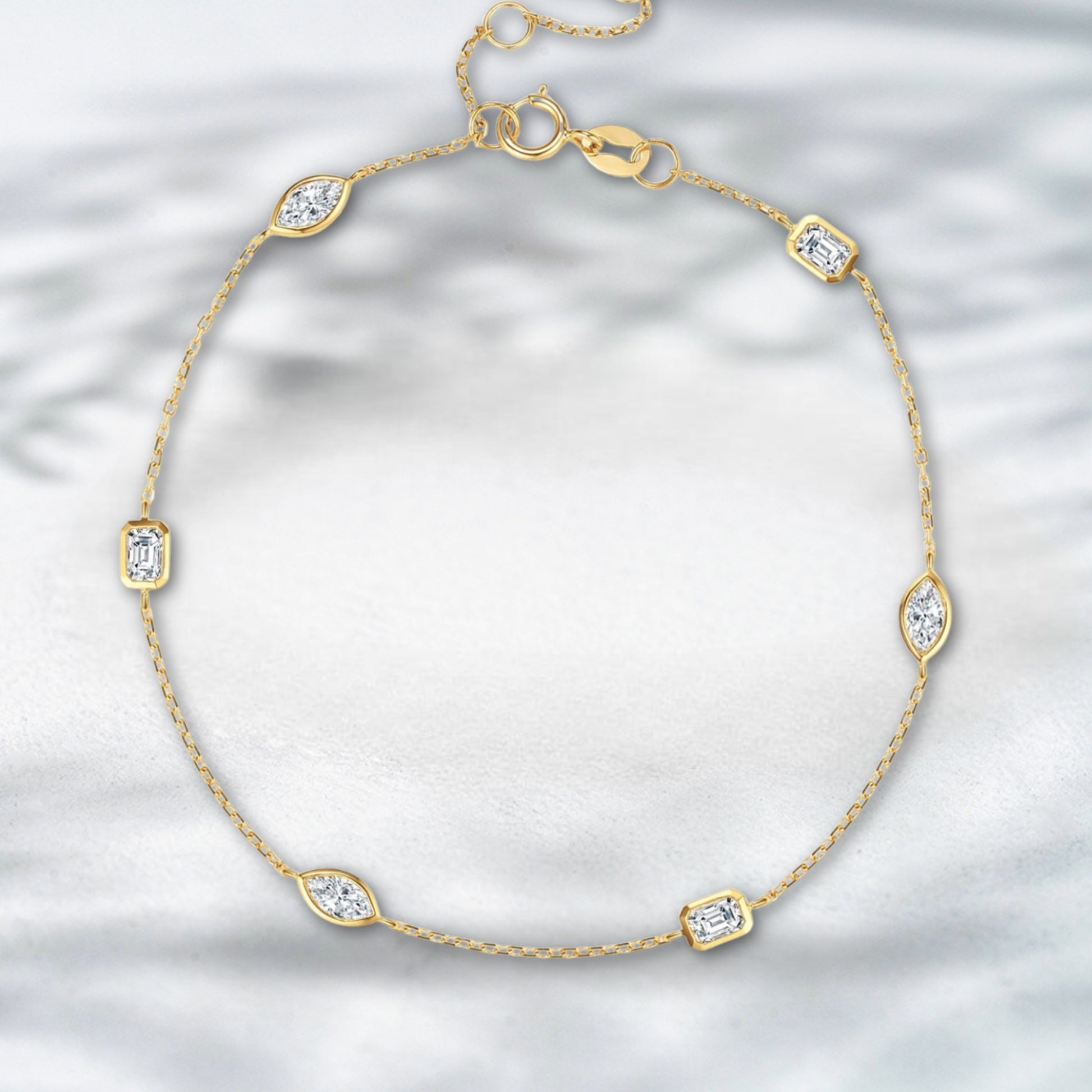 Gold bracelet with diamond accents on a light gray background