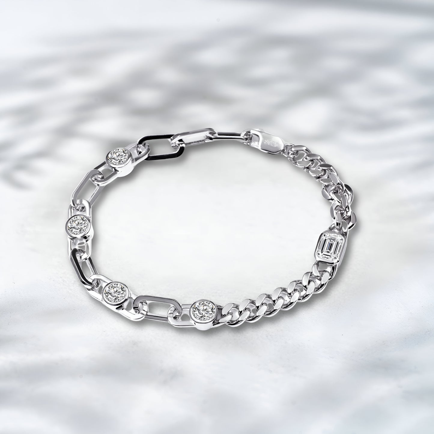Silver bracelet with embedded diamonds on a textured silver background