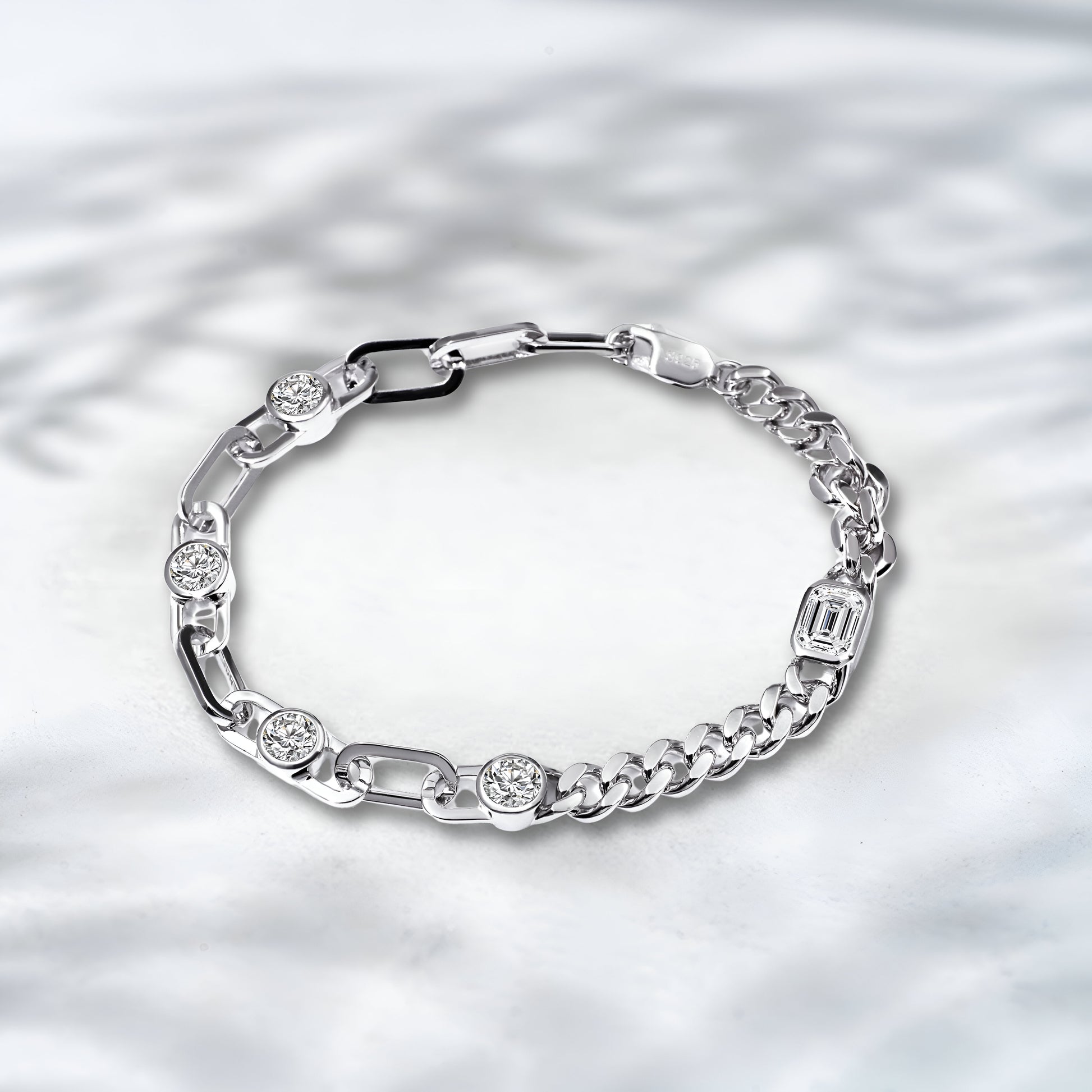 Silver bracelet with embedded diamonds on a textured silver background
